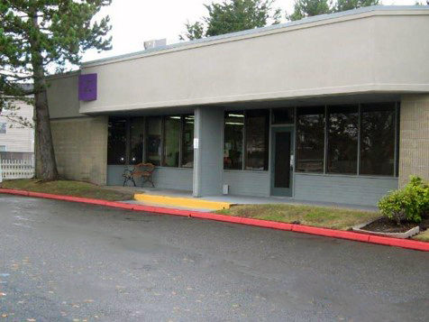 Everett a gray one story building with a red fire lane in front of it located in everett