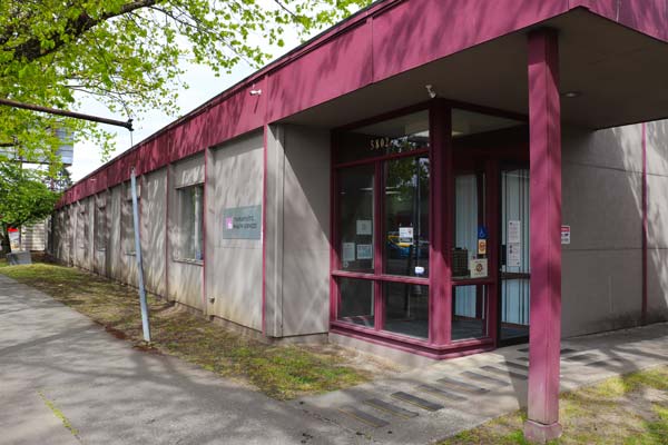 small one story building with purple trim, our rainier branch