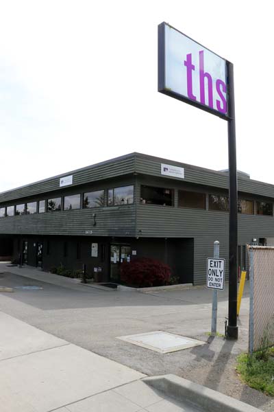 Shoreline two story gray building just off the highway with a large THS sign Shoreline branch