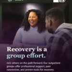 Photo of a woman laughing warmly while talking with a man in a plaid jacket, seen from behind, in a dimly lit indoor space. Purple gradient rises from the bottom. Support Groups badge (heart-with-hands icon) top left, THS logo top right. Bold white and mint serif headline: "Recovery is a group effort." Body text explains that THS's outpatient groups offer professional support, peer connection, and proven tools for recovery. "Swipe to learn more" bottom left, rightward pointing arrow icon bottom right.